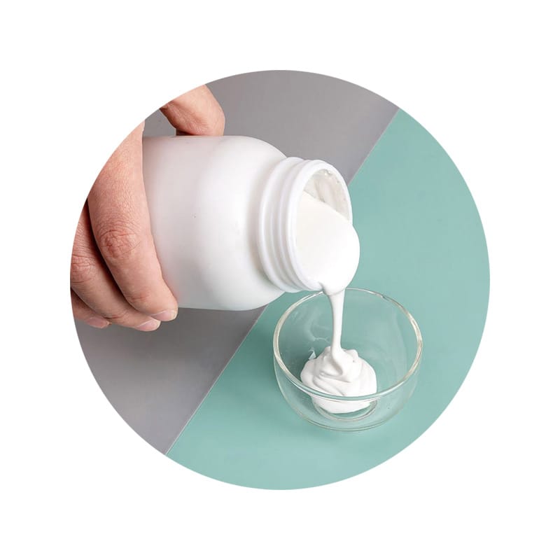 Thick white paste poured from a bottle into a clear bowl