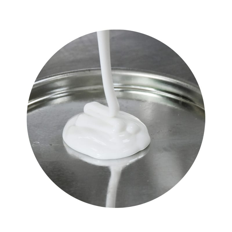 Thick white liquid poured onto a circular metal surface