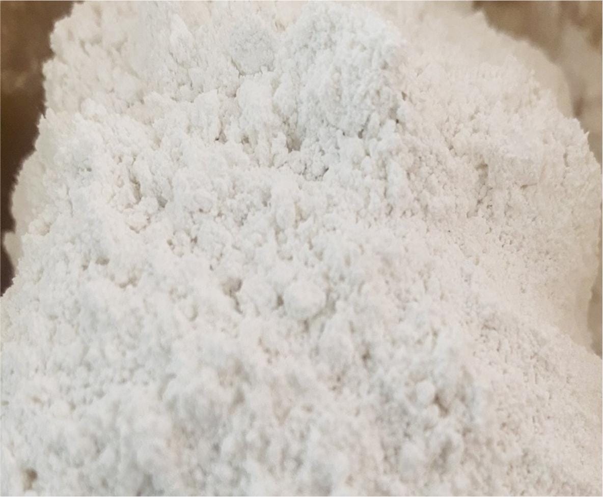 Macro close-up of fine clumpy white chemical powder