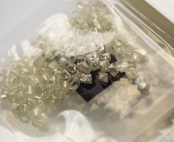 Plastic bag of similar-size octahedral rough diamonds