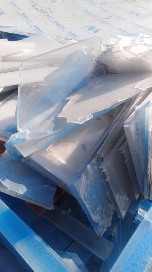 Clear acrylic scrap with blue protective film and Setacryl branding in a blue bin
