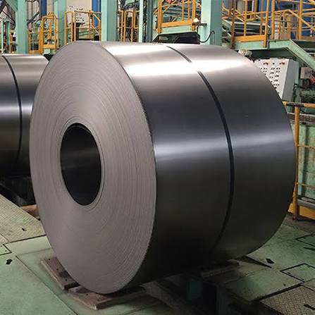 Large carbon steel coil strapped in an industrial warehouse